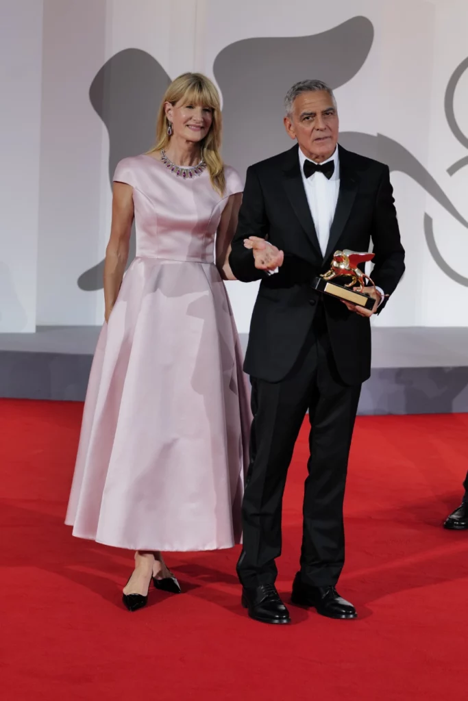George Clooney and Laura Dern sharing a candid moment on the red carpet, Venice Film Festival 2026 – Ph. Barbara Pigazzi, Studio Animica