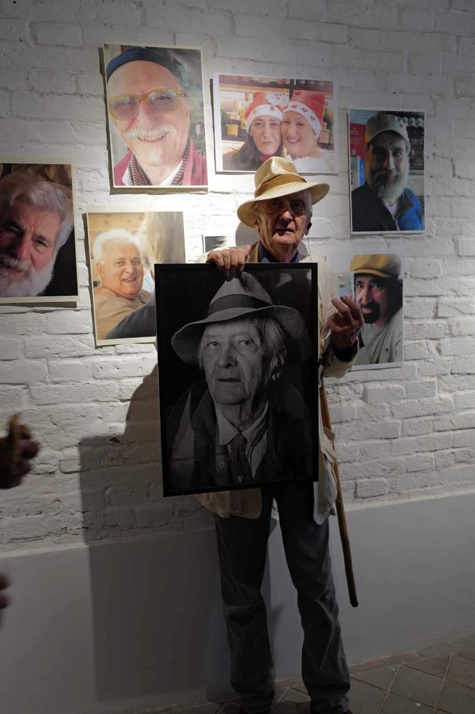 Italo Zannier holding his portrait by Barbara Pigazzi at his exhibition on the Giudecca
